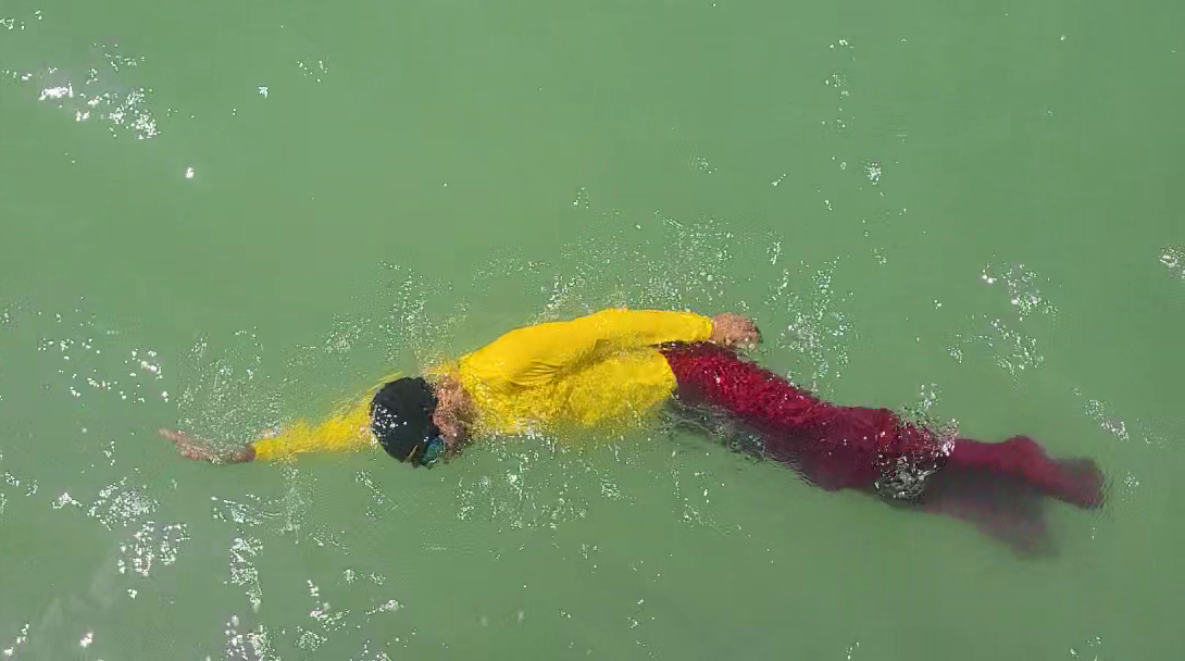 AquaQi fabric opening between the swimmer's legs like an underwater sail